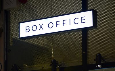Box office with a sign reading 'BOX OFFICE' above a window display