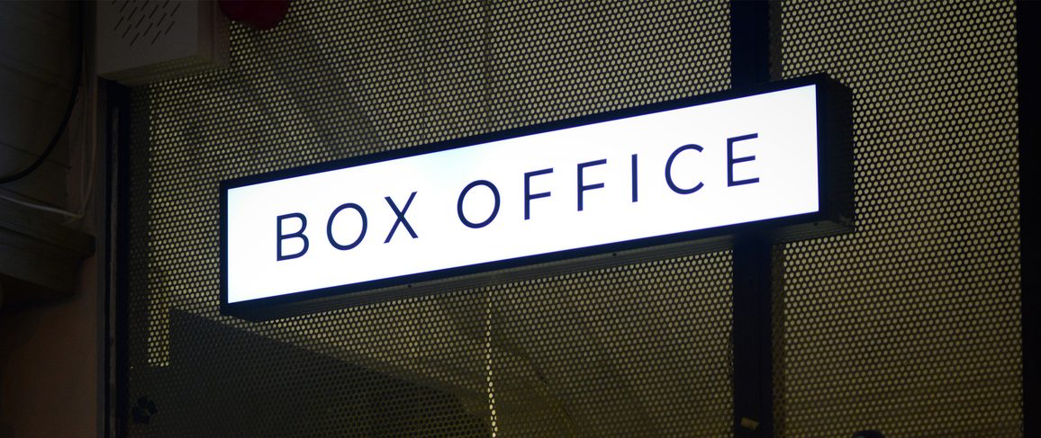 Box office with a sign reading 'BOX OFFICE' above a window display