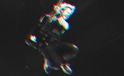 Person mid-air holding an electric guitar, captured in a dynamic pose with bent legs and arms gripping the instrument; glitch effect with red and blue outlines enhances the vibrant look against a dark background.