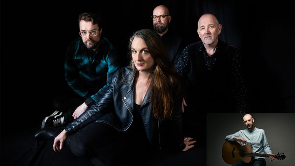Four people posing against a dark background; the person in front wears a black leather jacket and has long hair, while the others behind wear a green plaid shirt and dark clothing. An inset at the bottom right shows someone sitting with an acoustic guitar.
