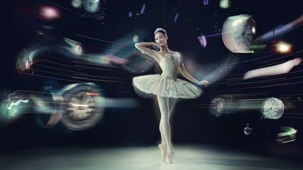 Ballerina in a white tutu standing on pointe with one arm raised, surrounded by clocks against a dark, starry, surreal background.