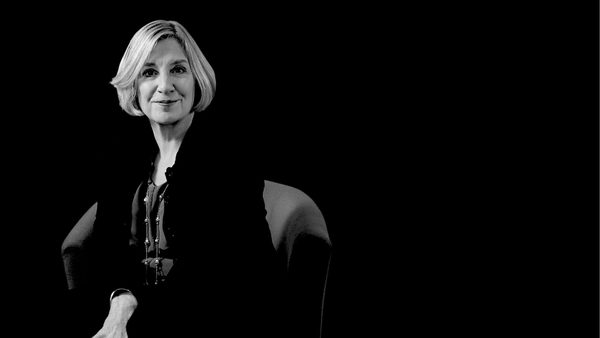 A black-and-white photo of a woman sitting calmly in a chair.